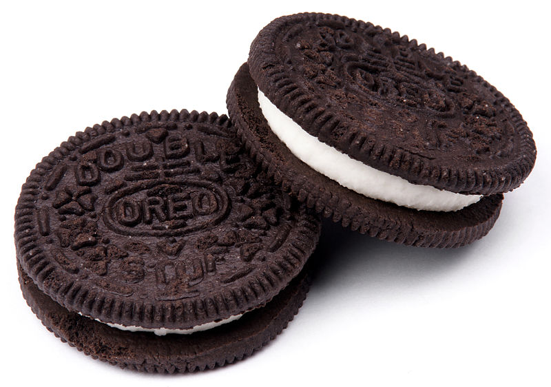 CAPTION A photo of two chocolate wafer cookies filled with white cream.