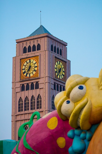 Shijingshan Amusement Park's bell tower, with a fish from a ride or building in the foreground