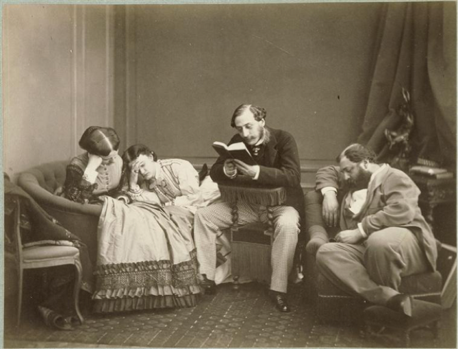 A man reading to a group of people who are either bored, sleeping, or dead.